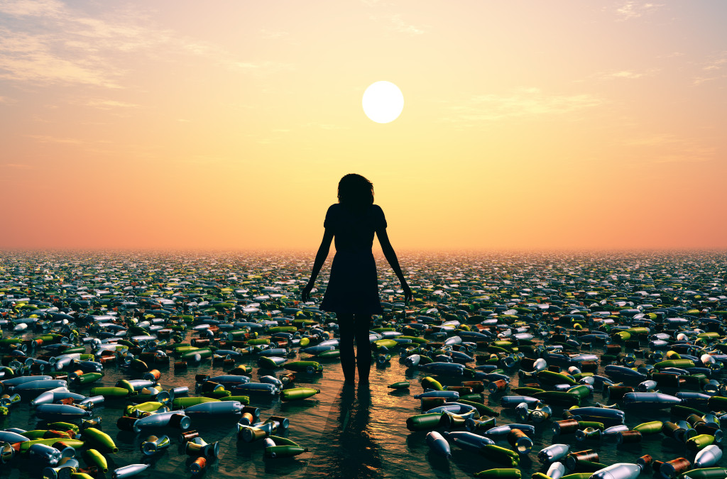 Silhouette of a woman in a sea of garbage.